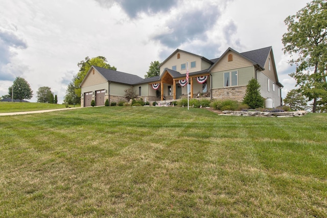 view of front facade featuring stone siding, a front lawn, and a garage