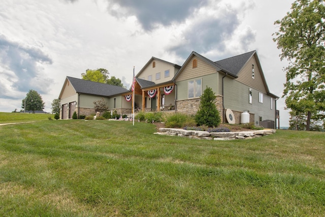 view of front of home with central air condition unit, stone siding, and a front lawn