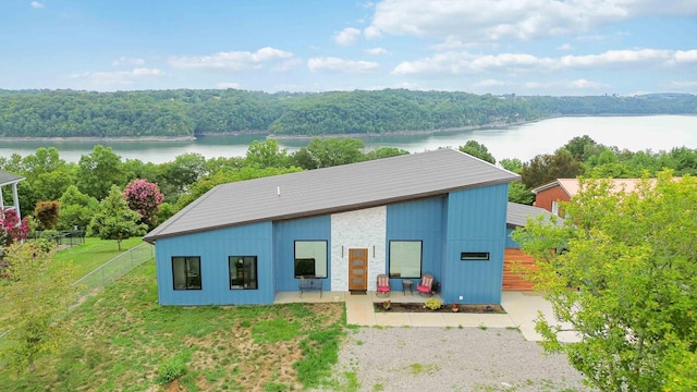 exterior space featuring a water view and a lawn