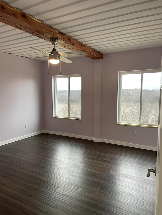 spare room with beamed ceiling, dark hardwood / wood-style floors, and ceiling fan