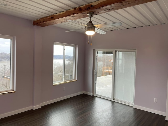 unfurnished room featuring ceiling fan, dark wood-type flooring, and beam ceiling