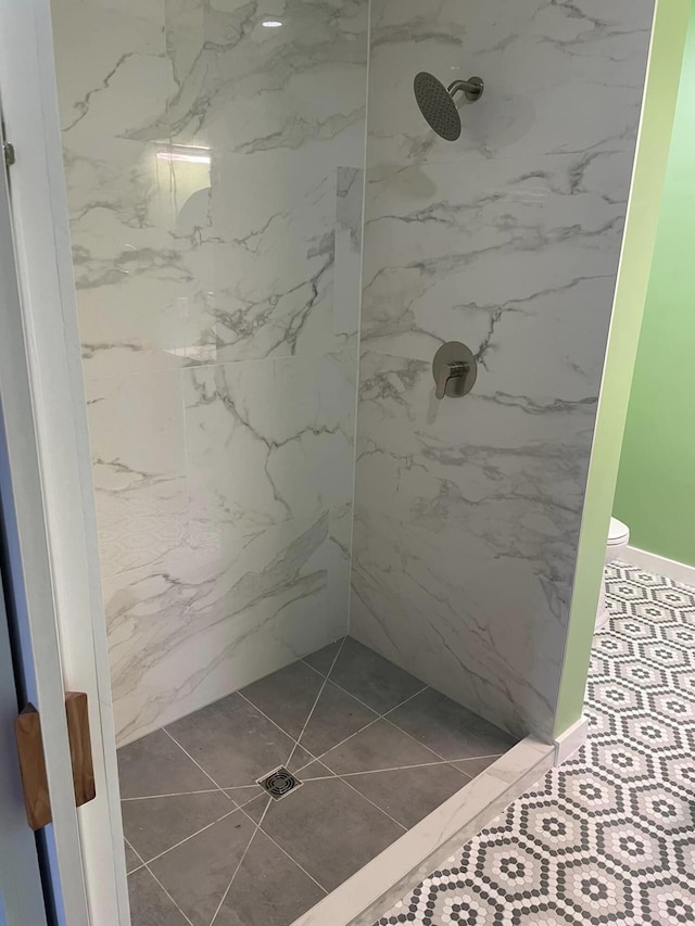 bathroom with tile patterned flooring and walk in shower