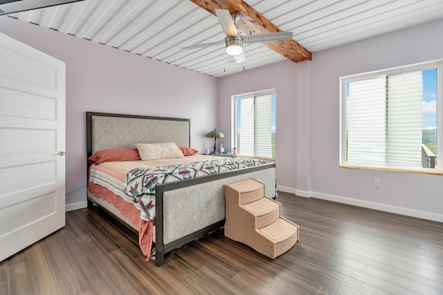 bedroom with beamed ceiling, dark wood-type flooring, and ceiling fan