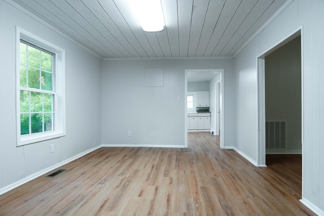 unfurnished room featuring wood ceiling, ornamental molding, and light hardwood / wood-style flooring