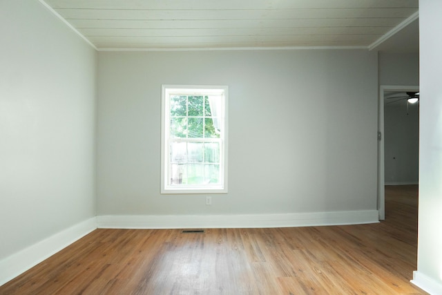 empty room with crown molding, ceiling fan, and light wood-type flooring