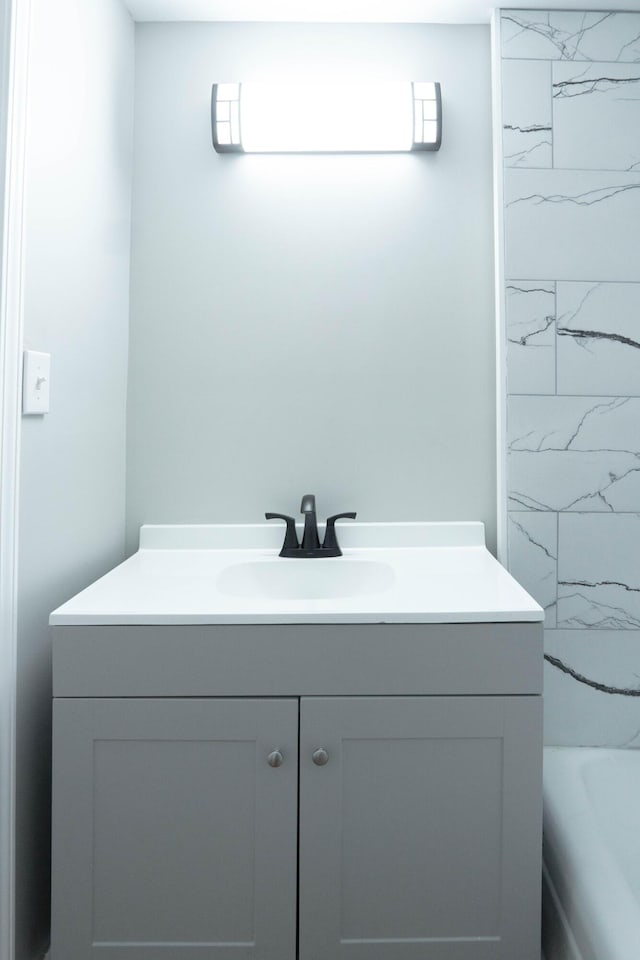 bathroom with vanity and a tub