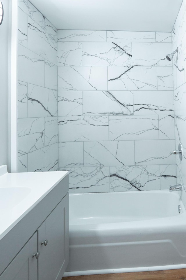 bathroom featuring vanity and tiled shower / bath combo