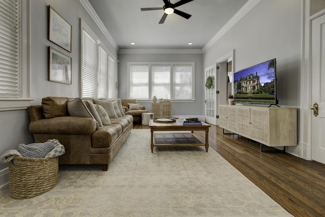 living room with hardwood / wood-style flooring, crown molding, and ceiling fan