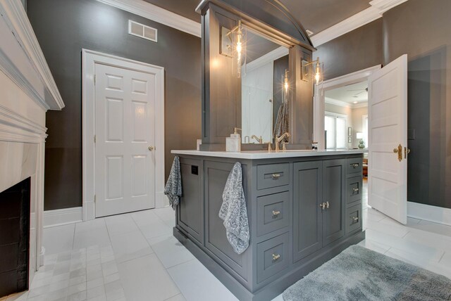 bathroom featuring vanity, crown molding, and tile patterned flooring