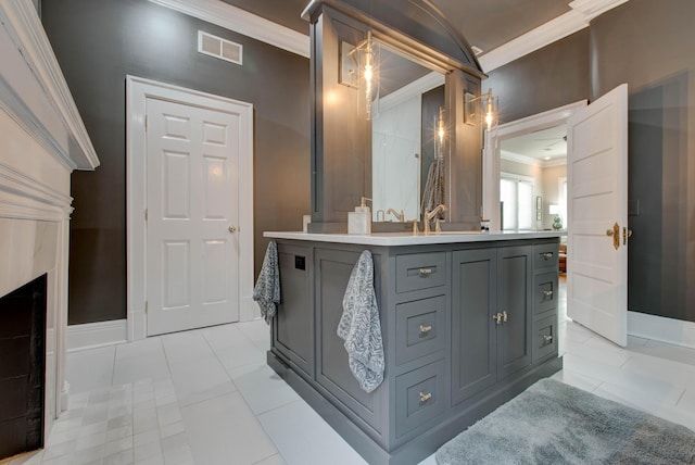 full bathroom with visible vents, baseboards, ornamental molding, vanity, and a fireplace