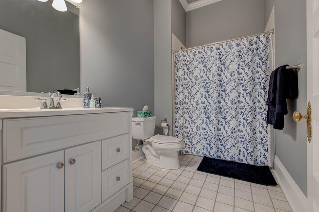 bathroom with tile patterned floors, crown molding, toilet, and vanity