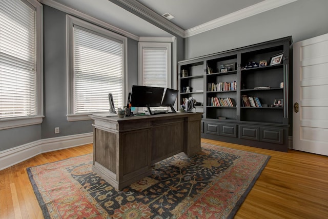 office with visible vents, crown molding, light wood-style flooring, and baseboards