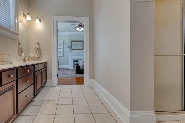 bathroom featuring vanity, tile patterned floors, ceiling fan, crown molding, and an enclosed shower