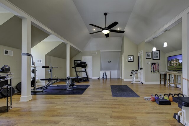 workout room featuring light hardwood / wood-style flooring, decorative columns, ceiling fan, and high vaulted ceiling