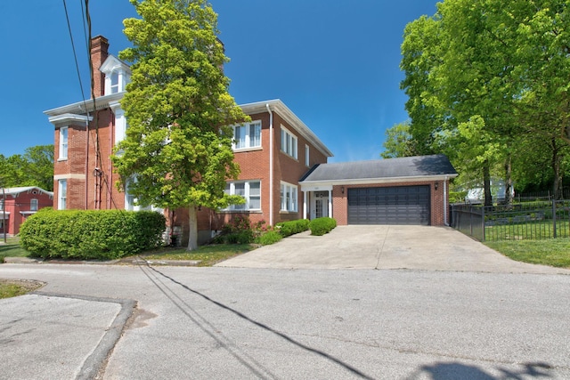 view of front of home with a garage, concrete driveway, brick siding, and fence