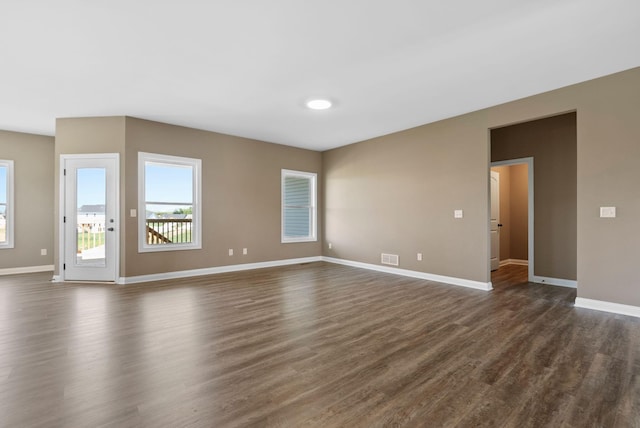 unfurnished living room featuring dark wood-type flooring