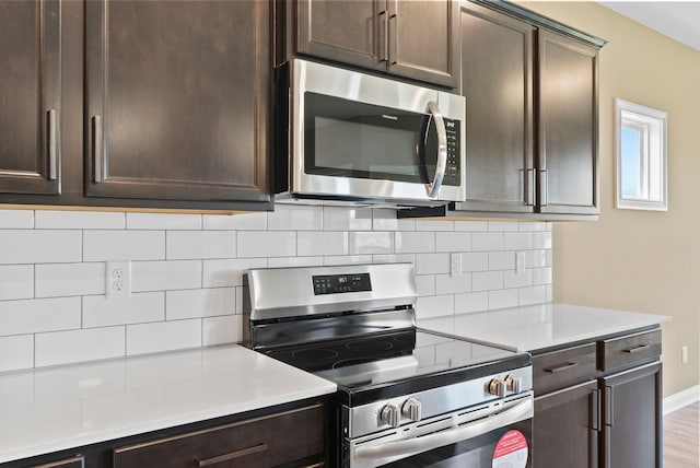 kitchen featuring decorative backsplash, dark brown cabinets, stainless steel appliances, and light hardwood / wood-style floors