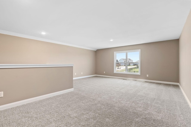 empty room with carpet and crown molding