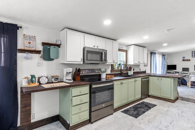 4743 Shoemaker Rdg, Zoe, KY 41397 - kitchen with green cabinets, marble finish floor, a sink, a peninsula, and appliances with stainless steel finishes
