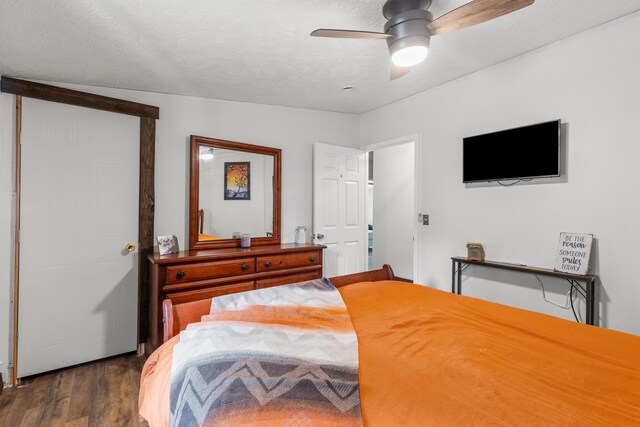 bedroom featuring dark hardwood / wood-style floors, ceiling fan, lofted ceiling, and a textured ceiling