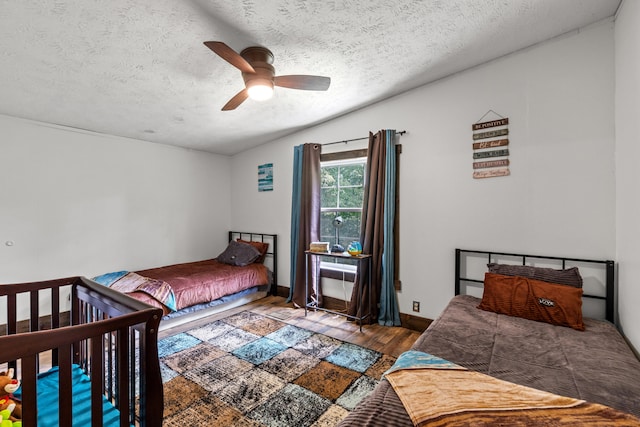 4743 Shoemaker Rdg, Zoe, KY 41397 - bedroom featuring vaulted ceiling, a ceiling fan, wood finished floors, and a textured ceiling