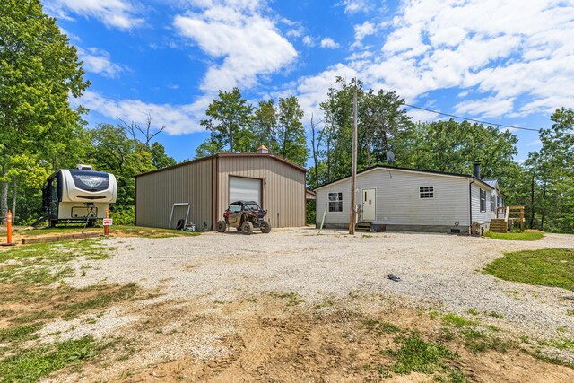 exterior space featuring a garage and an outbuilding