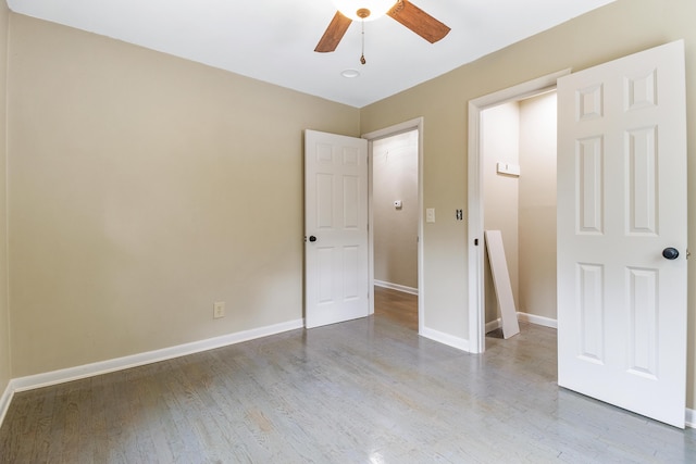 unfurnished bedroom featuring hardwood / wood-style flooring and ceiling fan