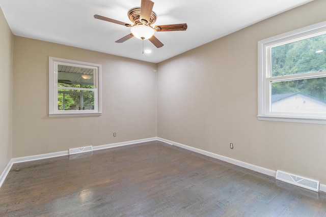 unfurnished room with ceiling fan and dark wood-type flooring