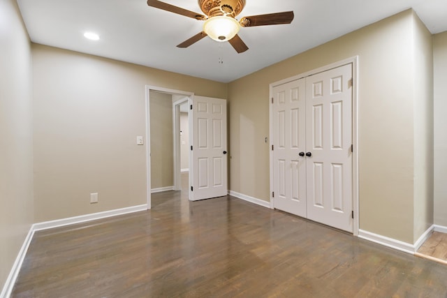 unfurnished bedroom featuring ceiling fan, dark wood-type flooring, and a closet