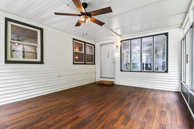 unfurnished sunroom with ceiling fan