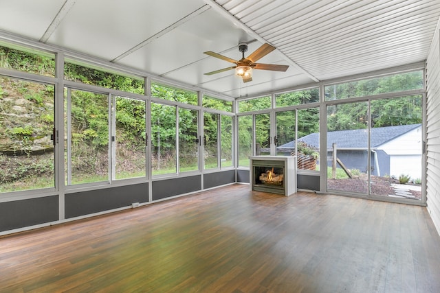 unfurnished sunroom with ceiling fan