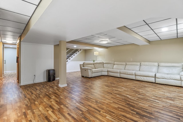 unfurnished living room with dark hardwood / wood-style flooring and a paneled ceiling