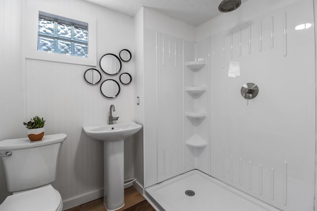 bathroom with sink, a shower, toilet, and hardwood / wood-style floors