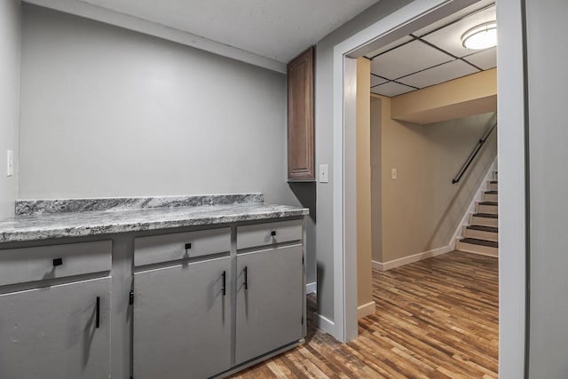 kitchen featuring hardwood / wood-style flooring and a paneled ceiling