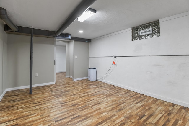 basement with wood-type flooring