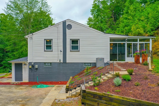 back of house with a patio area and a sunroom