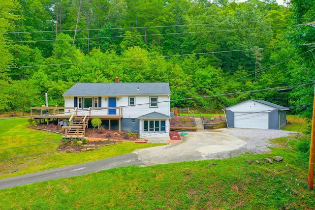 view of front facade featuring a front yard, a garage, an outdoor structure, and a wooden deck