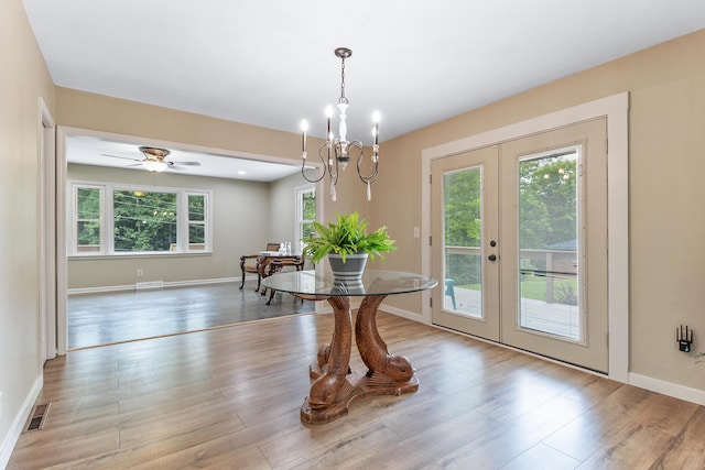 dining room featuring light wood-type flooring, french doors, and a wealth of natural light