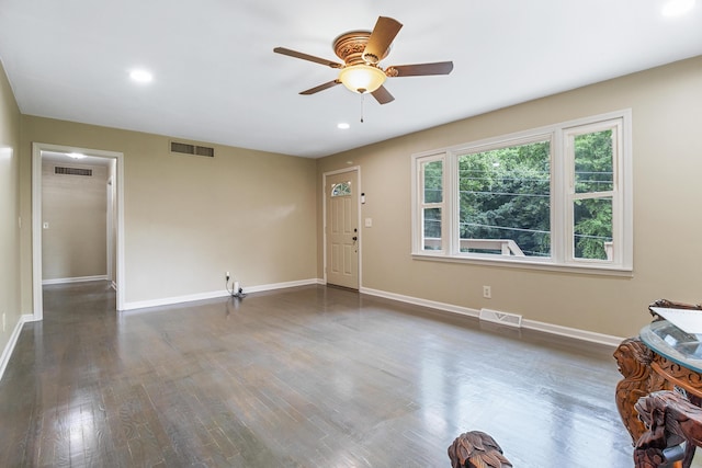 interior space with ceiling fan and dark hardwood / wood-style floors