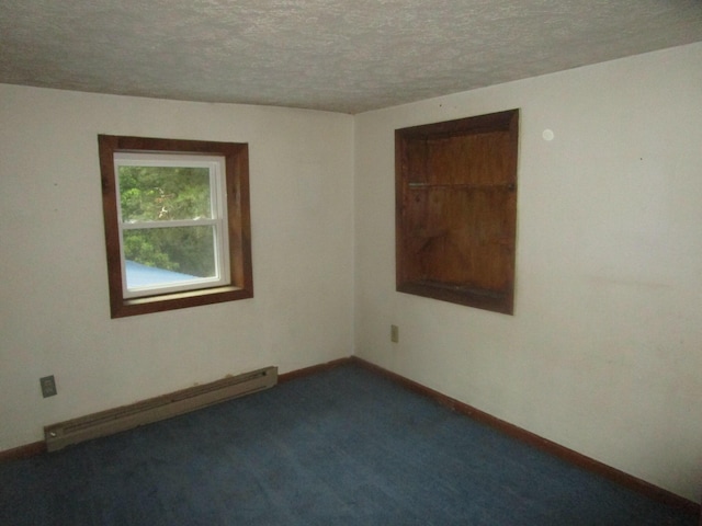 carpeted spare room featuring a textured ceiling and baseboard heating