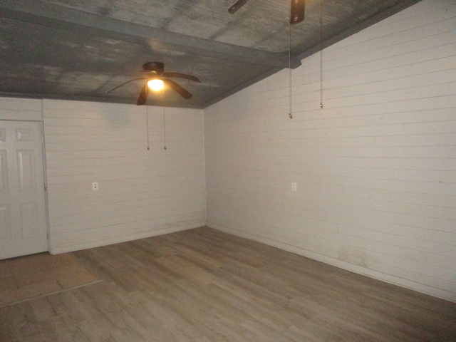 basement featuring hardwood / wood-style flooring and ceiling fan