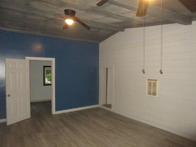 spare room featuring vaulted ceiling with beams, dark hardwood / wood-style floors, and ceiling fan