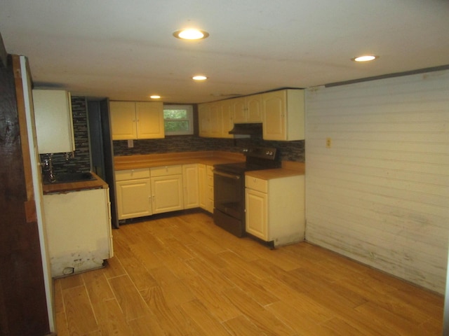 kitchen featuring black range with electric stovetop, sink, and light hardwood / wood-style flooring