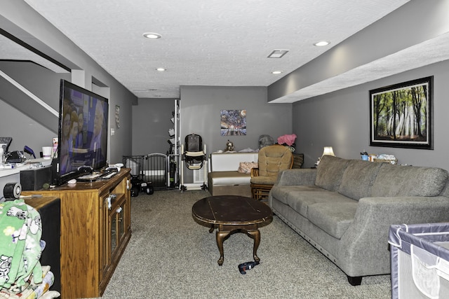 living room featuring carpet floors and a textured ceiling