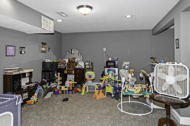 game room featuring carpet floors and a textured ceiling