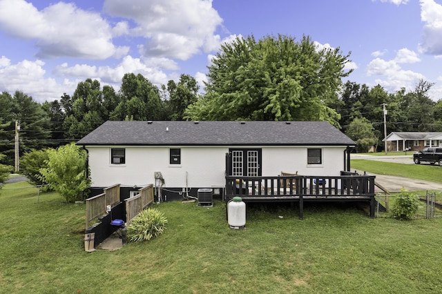 back of house with central AC, a yard, and a wooden deck