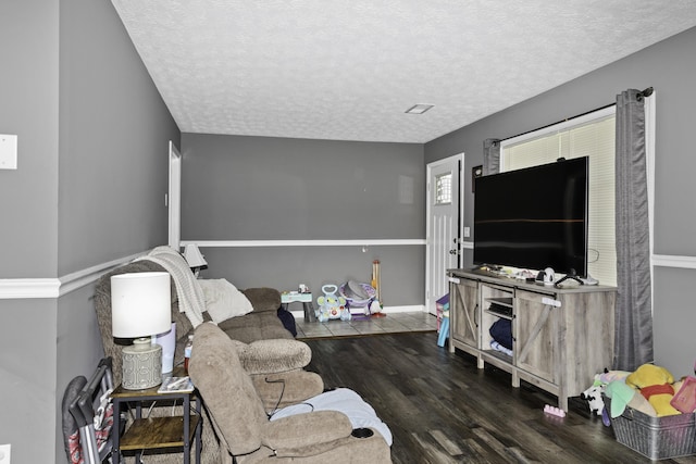 living room featuring dark hardwood / wood-style floors and a textured ceiling