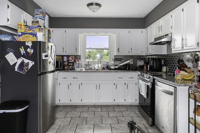 kitchen with white cabinetry, sink, dark stone countertops, and appliances with stainless steel finishes