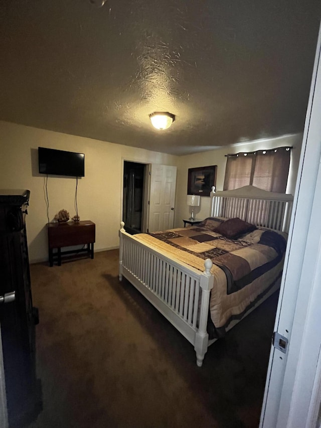 carpeted bedroom featuring a textured ceiling