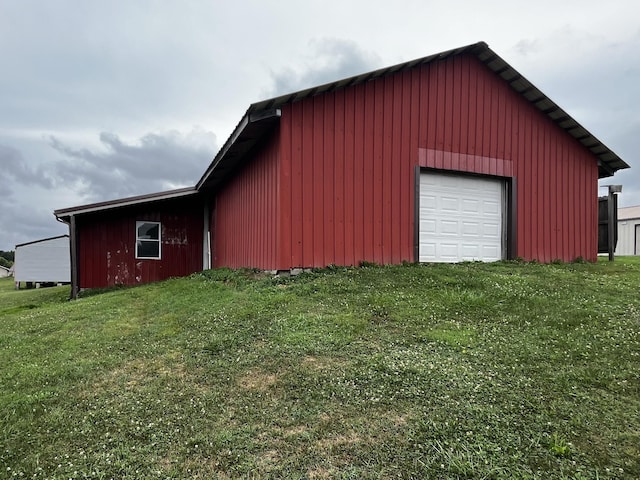 view of outbuilding featuring a garage and a lawn